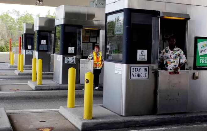 Cashless toll gantry glowing at dusk